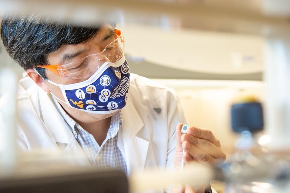 Xingbo Liu working on a fuel cell in his lab
