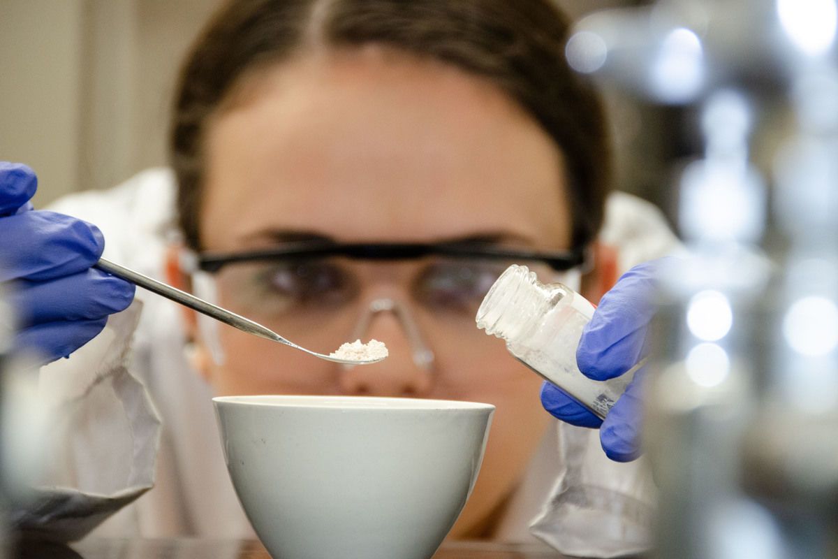 Female researcher measuring ingredients